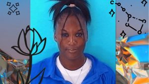 Picture depicts a chic dark-skinned female wearing a blue jumpsuit with black straightened hair pulled into a high ponytail